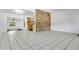 Open floor plan with tile floors, stone wall accent, and open kitchen space at 1148 Northcrest Dr, Apopka, FL 32703