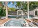 The backyard oasis features a pool and in-ground hot tub surrounded by lush landscaping at 1148 Northcrest Dr, Apopka, FL 32703