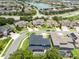 Scenic aerial view showcasing a beautiful neighborhood with lush landscaping and a serene lake nearby at 11850 Sheltering Pine Dr, Orlando, FL 32836