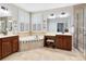 Bright bathroom features double sinks, large soaking tub, vanity, and a glass-enclosed walk-in shower at 11850 Sheltering Pine Dr, Orlando, FL 32836