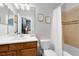 Clean bathroom featuring tub with shower, white tiling, modern fixtures, and bright lighting at 11850 Sheltering Pine Dr, Orlando, FL 32836