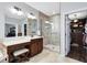 Stylish bathroom with glass shower, vanity, and a view of the walk-in closet at 11850 Sheltering Pine Dr, Orlando, FL 32836