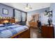 Cozy bedroom featuring natural light, ceiling fan, hardwood floors, and a closet at 11850 Sheltering Pine Dr, Orlando, FL 32836