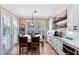 Bright kitchen with white cabinets, granite countertops and stainless steel appliances at 11850 Sheltering Pine Dr, Orlando, FL 32836
