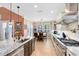 Bright kitchen with granite countertops, tile backsplash, and stainless steel appliances at 11850 Sheltering Pine Dr, Orlando, FL 32836
