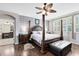 Bedroom with hardwood floors, ceiling fan, and a walk-in closet at 11850 Sheltering Pine Dr, Orlando, FL 32836