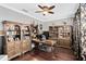 Office with hardwood floors, built-in bookshelves and a ceiling fan at 11850 Sheltering Pine Dr, Orlando, FL 32836