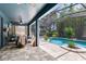 A spacious lanai area boasts an outdoor seating area with access to the screened-in pool and backyard at 11850 Sheltering Pine Dr, Orlando, FL 32836