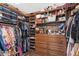 Spacious walk-in closet with custom shelving and drawers for optimal storage at 11850 Sheltering Pine Dr, Orlando, FL 32836