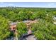 Aerial view of community with tile roofs surrounded by mature trees, close to downtown skyline at 1217 Salerno Ct # 1217, Orlando, FL 32806
