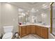 Bathroom featuring double sinks, wood cabinets, and large mirrors for a bright, spacious feel at 1217 Salerno Ct # 1217, Orlando, FL 32806