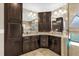 Double vanity with granite countertops, dark wood cabinets, and designer lighting fixtures in this spacious bathroom at 1217 Salerno Ct # 1217, Orlando, FL 32806