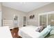 Bedroom with wood floors, light walls, access to the bathroom, and a sliding glass door for outdoor access at 1217 Salerno Ct # 1217, Orlando, FL 32806