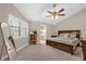 A spacious bedroom with neutral walls and trim, carpeted floors, shuttered windows, and a ceiling fan at 1217 Salerno Ct # 1217, Orlando, FL 32806