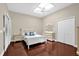 Bright bedroom with skylight, wood floors, and white furniture, including a dresser and bedside table at 1217 Salerno Ct # 1217, Orlando, FL 32806