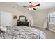 Vaulted ceilings with ceiling fan fixture compliment a bedroom with neutral walls, and a large dresser at 1217 Salerno Ct # 1217, Orlando, FL 32806