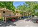 A well maintained apartment complex with mature landscaping, covered parking, and a terracotta tile roof at 1217 Salerno Ct # 1217, Orlando, FL 32806