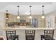 Well-equipped kitchen with granite countertops, stainless steel appliances and pendant lighting above the bar at 1217 Salerno Ct # 1217, Orlando, FL 32806