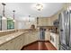 Kitchen with stainless steel appliances, granite countertops, a breakfast bar, and hardwood floors at 1217 Salerno Ct # 1217, Orlando, FL 32806