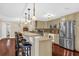 The kitchen features stainless steel appliances, granite countertops and hardwood floors at 1217 Salerno Ct # 1217, Orlando, FL 32806