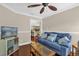Comfortable living room with a blue sofa, wood floors, and a view into the kitchen and bar at 1217 Salerno Ct # 1217, Orlando, FL 32806