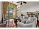 Open living room with floor-to-ceiling window, ceiling fan, and view of the kitchen and balcony at 1217 Salerno Ct # 1217, Orlando, FL 32806