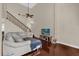 Comfortable living room with hardwood floors, a staircase, and a bright, open atmosphere at 1217 Salerno Ct # 1217, Orlando, FL 32806