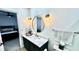 Stylish bathroom featuring a round mirror, modern vanity, and gold accents at 12621 Tanja King Blvd, Orlando, FL 32828