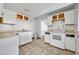 Kitchen with white cabinets and appliances, ready for updates at 1308 Oregon St, Orlando, FL 32803