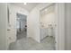 Hallway view showcasing a bedroom and a separate laundry room with washer and dryer at 133 Hickory Course Circle, Ocala, FL 34472