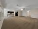 Spacious living area with carpet flooring and views of the kitchen and hallway at 133 Hickory Course Circle, Ocala, FL 34472