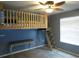 Unique bedroom with a lofted bed, ladder access, and blue accent wall at 1420 Center St, Ocoee, FL 34761