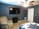 Bedroom featuring a ceiling fan, plush recliner, and a flat screen television at 1420 Center St, Ocoee, FL 34761