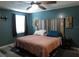 Bedroom boasts a custom wood headboard with mounted lights, ceiling fan, and sleek, modern flooring at 1420 Center St, Ocoee, FL 34761