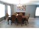 Formal dining room with elegant chandelier, ample space for entertaining, and neutral color palette at 1420 Center St, Ocoee, FL 34761