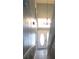 Entrance foyer with a large window above the front door, a chandelier, and stairwell with decorative wainscoting at 1420 Center St, Ocoee, FL 34761