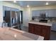 Bright kitchen featuring stainless steel appliances, light gray cabinetry, and a kitchen island with marble countertop at 1420 Center St, Ocoee, FL 34761