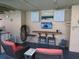 Screened in outdoor kitchen features a bar, tv, seating, and connection to pool at 1420 Center St, Ocoee, FL 34761