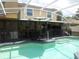 A sparkling pool features a built-in hot tub and is screened-in for privacy at 1420 Center St, Ocoee, FL 34761