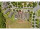 Aerial view of a suburban home with a large backyard, neighboring houses, and community park at 15424 Sweet Orange Ave, Winter Garden, FL 34787