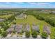 Overhead view of several homes with lush green lawns, and surrounding fields at 15424 Sweet Orange Ave, Winter Garden, FL 34787