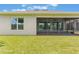 Exterior of screened-in patio with ceiling fan overlooking the lawn at 15424 Sweet Orange Ave, Winter Garden, FL 34787