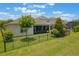 Well-maintained backyard showing the home's exterior and the screened lanai at 15424 Sweet Orange Ave, Winter Garden, FL 34787