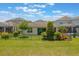 Well-maintained backyard showing the home's exterior and screened lanai at 15424 Sweet Orange Ave, Winter Garden, FL 34787
