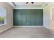 Bedroom with tray ceiling, carpet flooring, accent wall, and ensuite bathroom at 15424 Sweet Orange Ave, Winter Garden, FL 34787