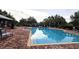 Community swimming pool with lounge chairs and a covered seating area, perfect for relaxation and recreation at 15424 Sweet Orange Ave, Winter Garden, FL 34787