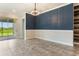 Elegant dining room featuring accent wall and sliding door access to outdoor patio at 15424 Sweet Orange Ave, Winter Garden, FL 34787