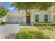 Charming single-story home with a well-manicured lawn, two-car garage and stone accents at 15424 Sweet Orange Ave, Winter Garden, FL 34787