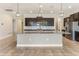 Spacious kitchen featuring granite countertops, large island, stainless steel appliances and modern lighting at 15424 Sweet Orange Ave, Winter Garden, FL 34787
