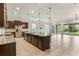 Modern kitchen with granite countertops, stainless steel appliances and large center island at 15424 Sweet Orange Ave, Winter Garden, FL 34787